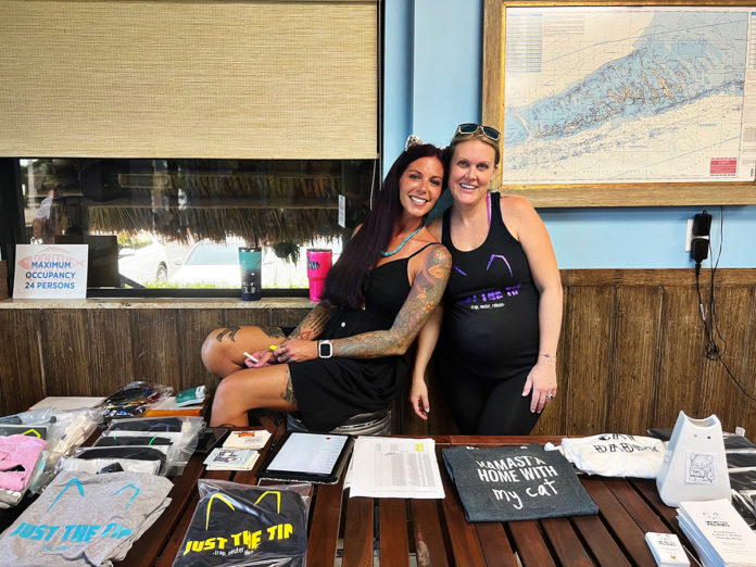 a couple of women standing next to each other at a table