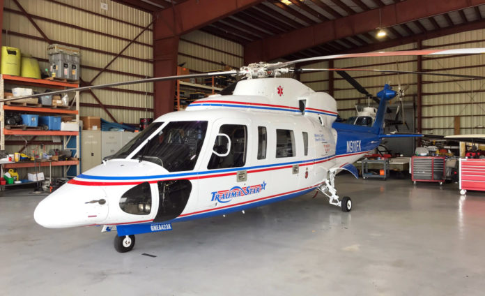 a white and blue helicopter in a warehouse