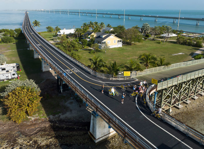 an aerial view of a bridge over a body of water