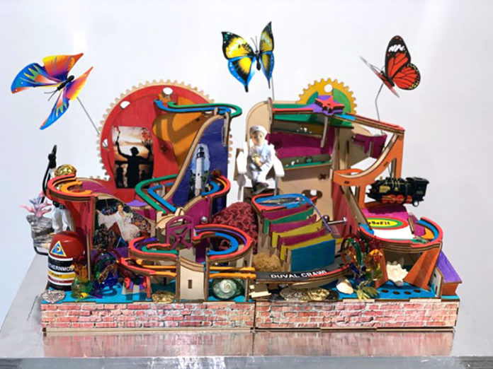 a sculpture of a building with a lot of different things on top of it