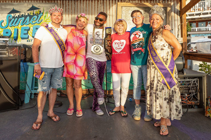 king-queen-&-candidates a group of people standing next to each other on a stage