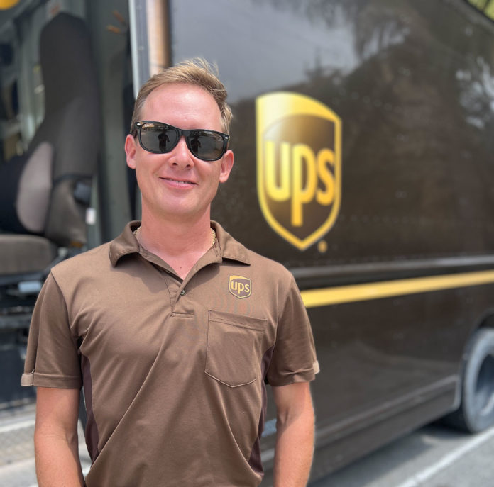 a man standing in front of a ups truck