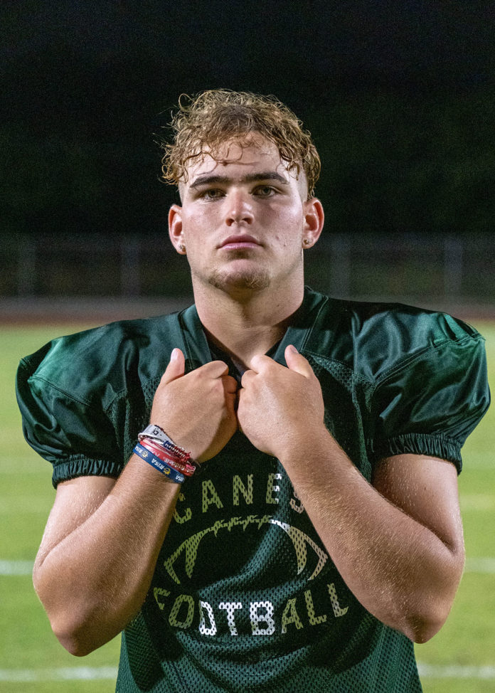 a man in a football uniform standing on a field