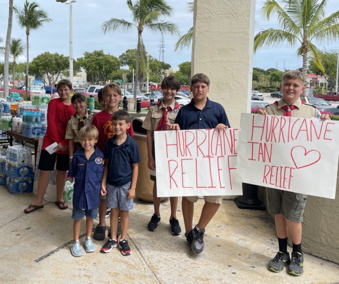 a group of people holding up signs in front of a building