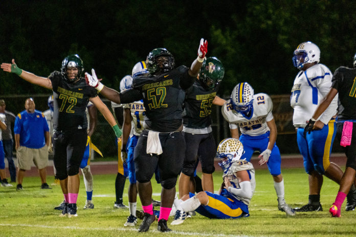 a group of football players standing on top of a field