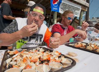 a group of people sitting at a table eating food