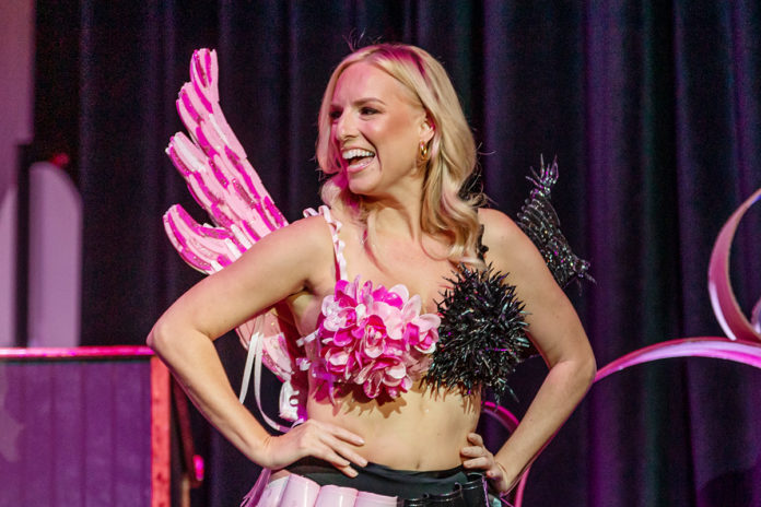 a woman in a pink and black costume