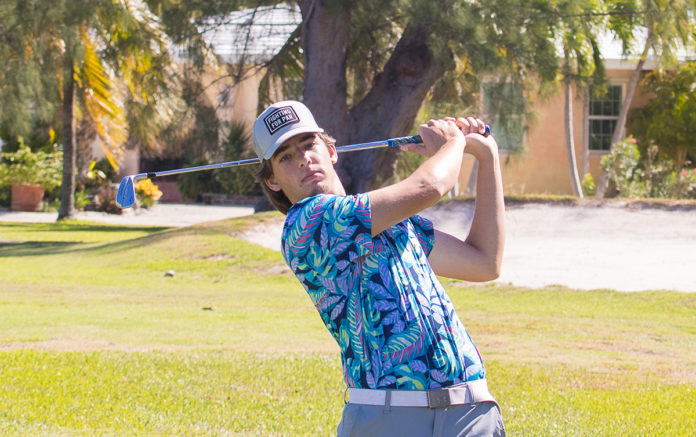 a man swinging a golf club on a golf course