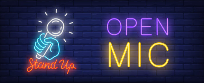 a neon sign that says open mic and a neon sign that says stand up