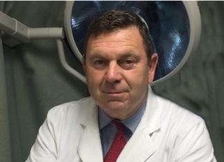 a man in a white lab coat and red tie