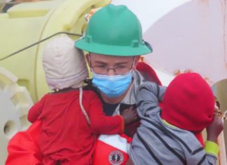 a man in a hard hat and a child wearing a face mask