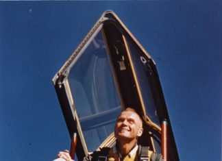 a man standing in the cockpit of an airplane