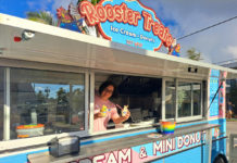 a food truck with a woman serving food