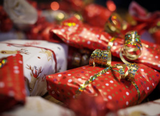 a pile of wrapped presents sitting on top of a table