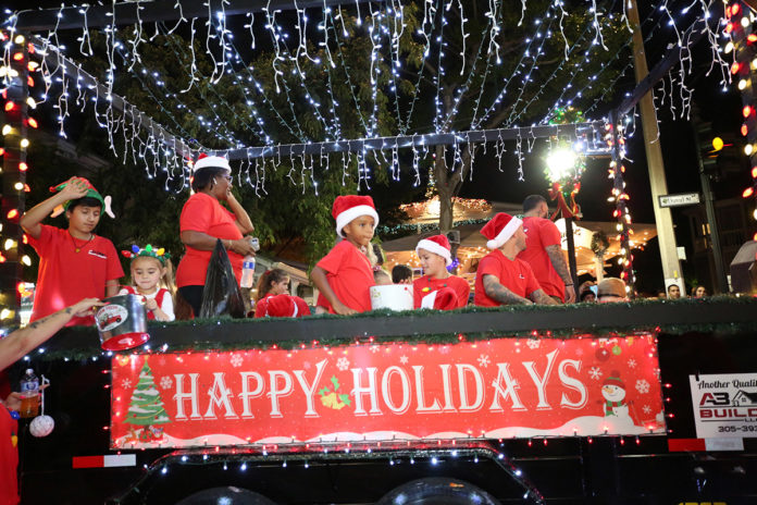 a group of people riding on the back of a truck