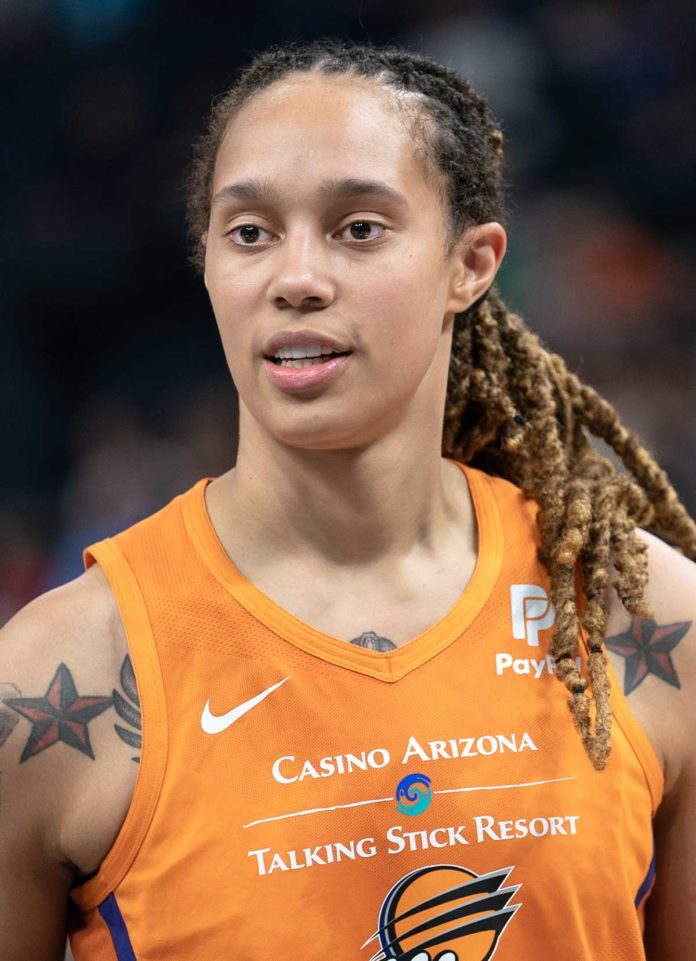 a female basketball player with dreadlocks on her head