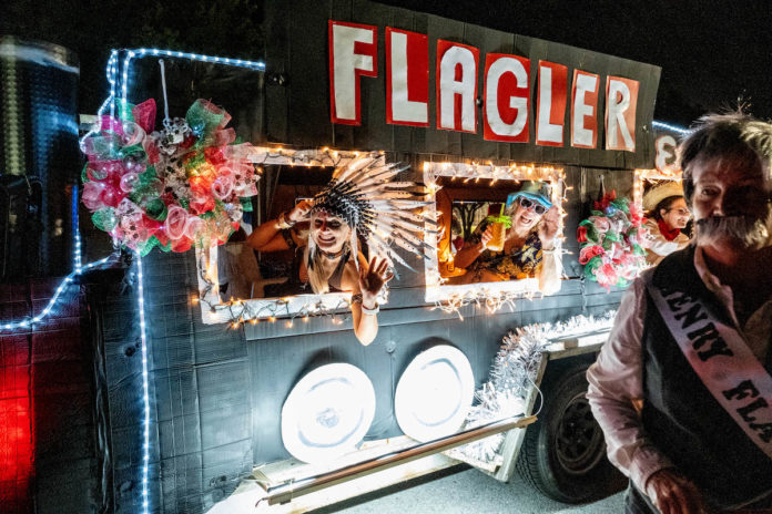 a man standing in front of a truck decorated with lights