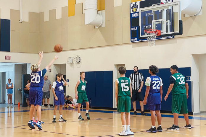 a group of young men playing a game of basketball