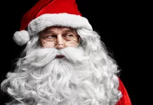 a man in a santa suit with a beard and glasses