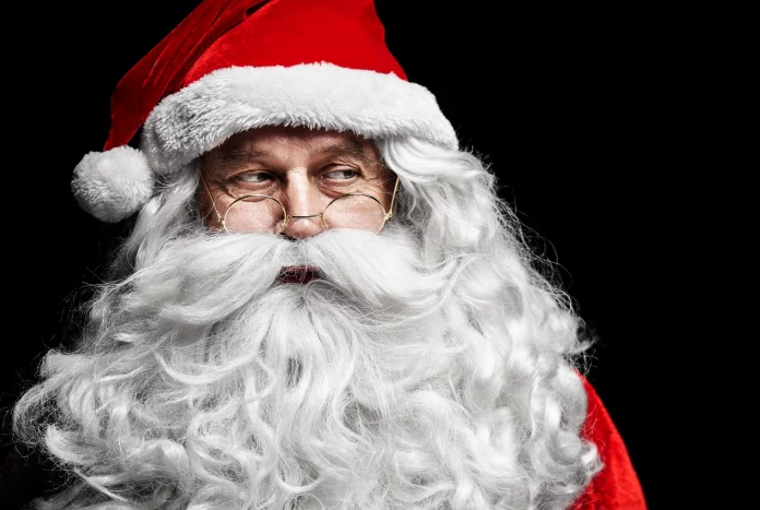 a man in a santa suit with a beard and glasses