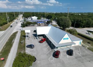 an aerial view of a gas station with cars parked in the lot