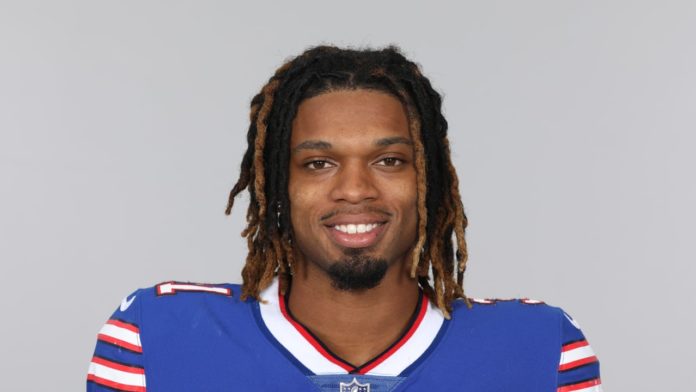 a close up of a football player wearing a blue uniform