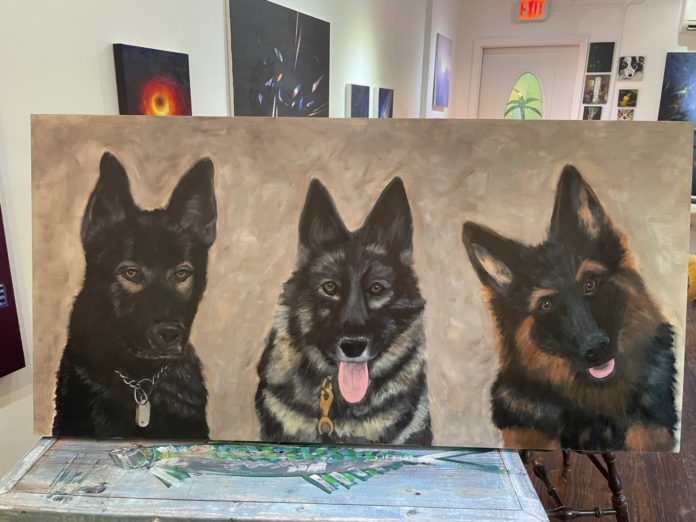 a painting of three dogs on a canvas