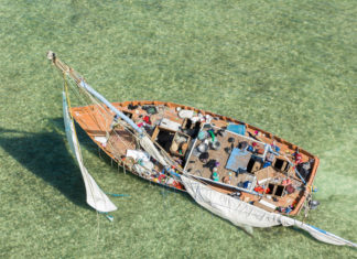 a boat with people on it floating in the water