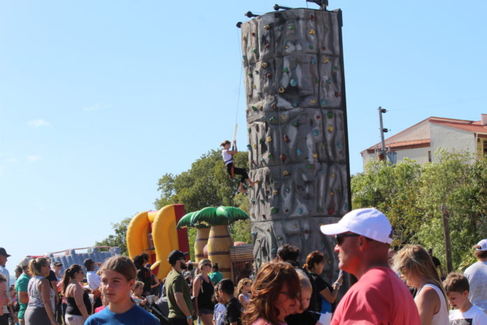 a group of people standing in front of a tall tower