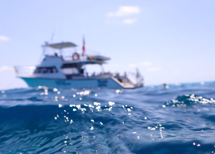 a boat in the ocean with a sky background