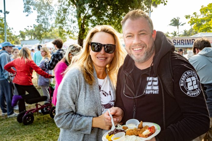 a man and a woman holding a plate of food