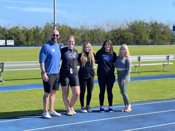 a group of people standing on a track