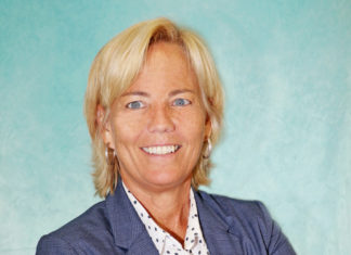 a woman with blonde hair and blue blazer smiling