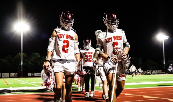 a group of young men walking across a football field