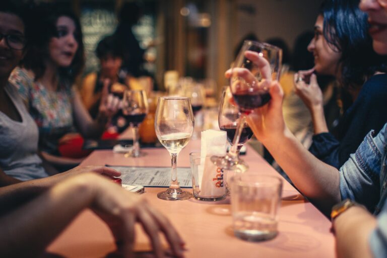 a group of people sitting at a table drinking wine
