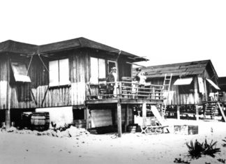 a black and white photo of a beach house
