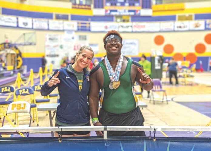 xavyer arrington Large a couple of people standing next to a swimming pool