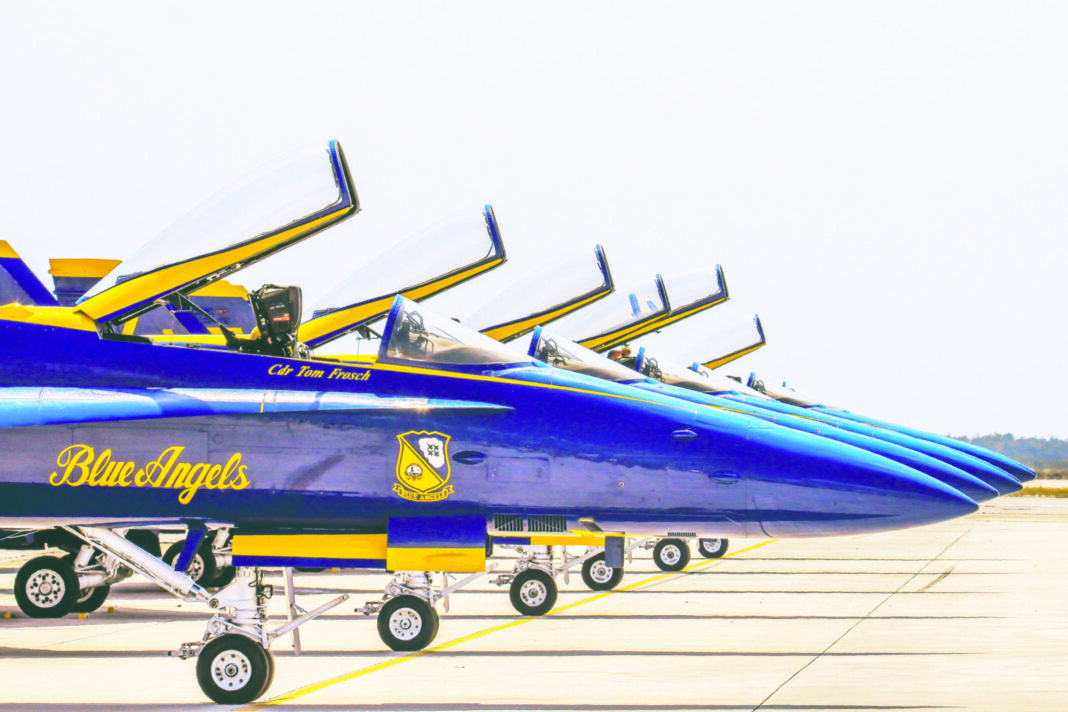 a row of blue angels jet planes sitting on top of an airport tarmac