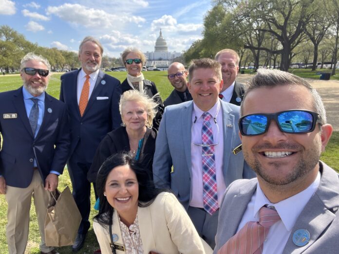 a group of people in suits and ties posing for a picture