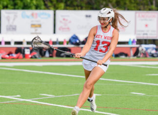a female lacrosse player in action on the field