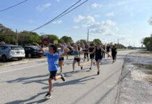 a group of people running down a street