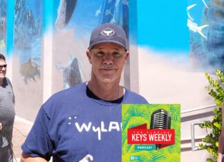 a man holding a book in front of a building