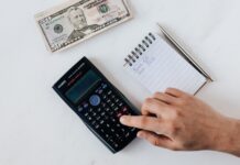 a person using a calculator on a table