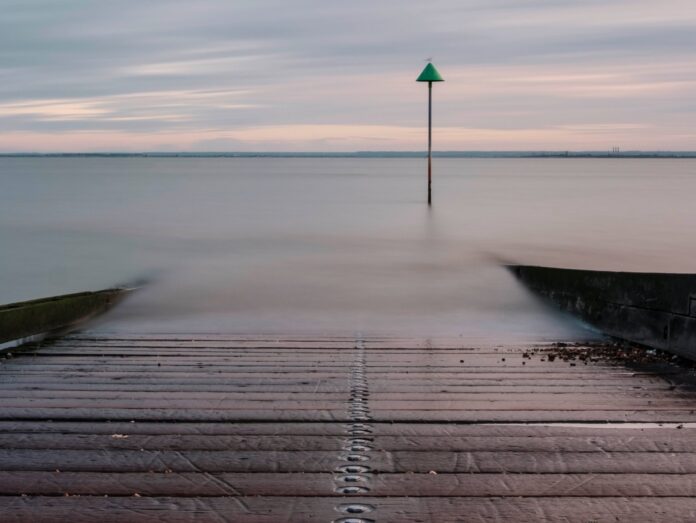 a long exposure photo of a pier in the water