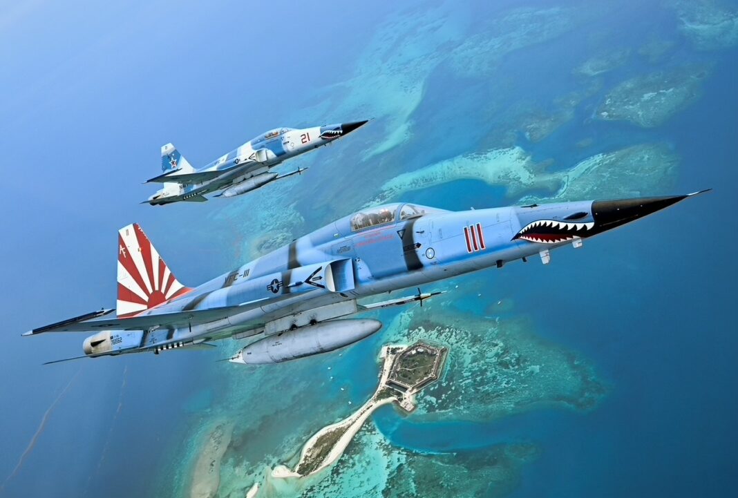 a group of fighter jets flying over a coral reef