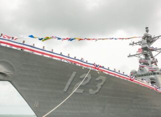 a large ship with a lot of flags on it
