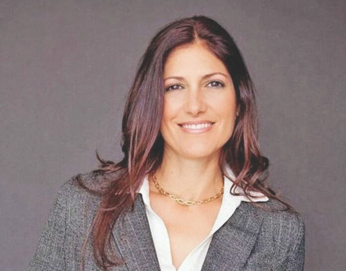 a woman in a business suit posing for a picture