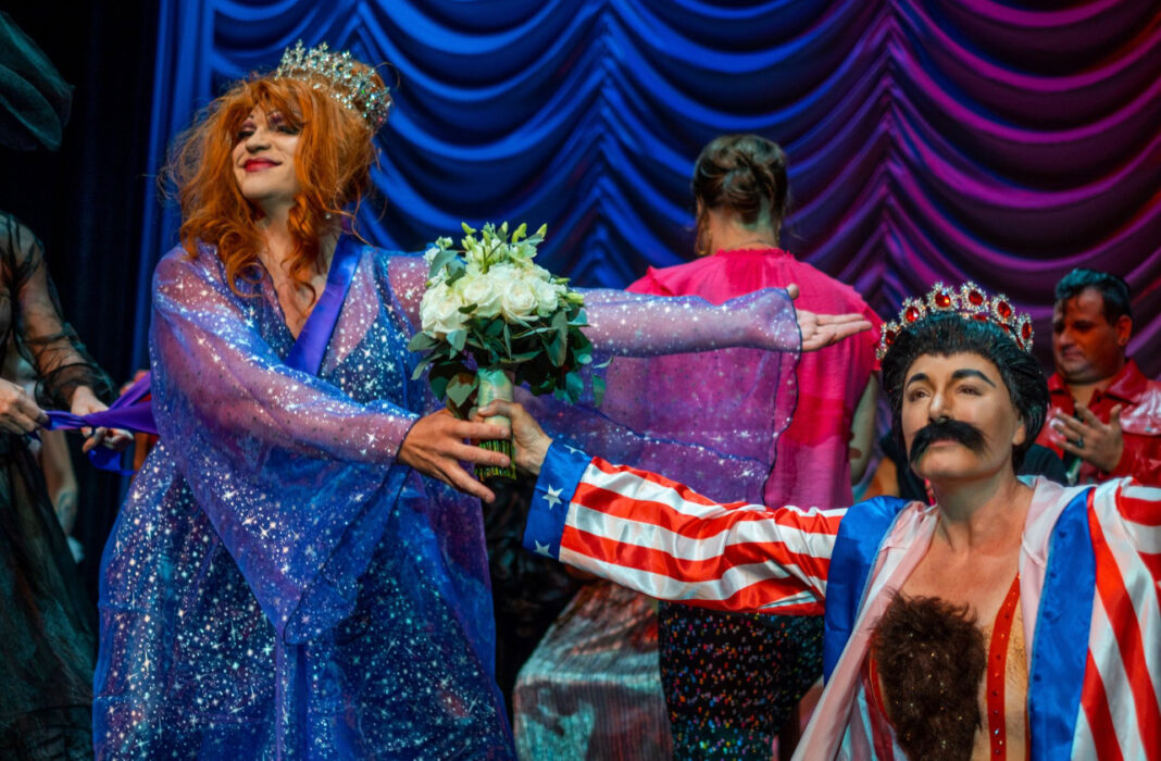 a group of people dressed in costumes on a stage