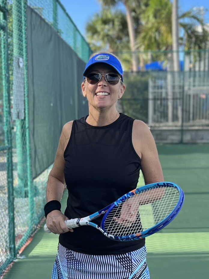 Christy Hughes a woman holding a tennis racquet on a tennis court