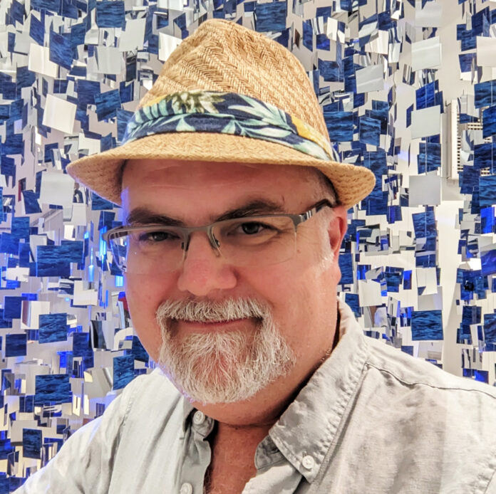 Dodds-Jed a man wearing a straw hat and glasses